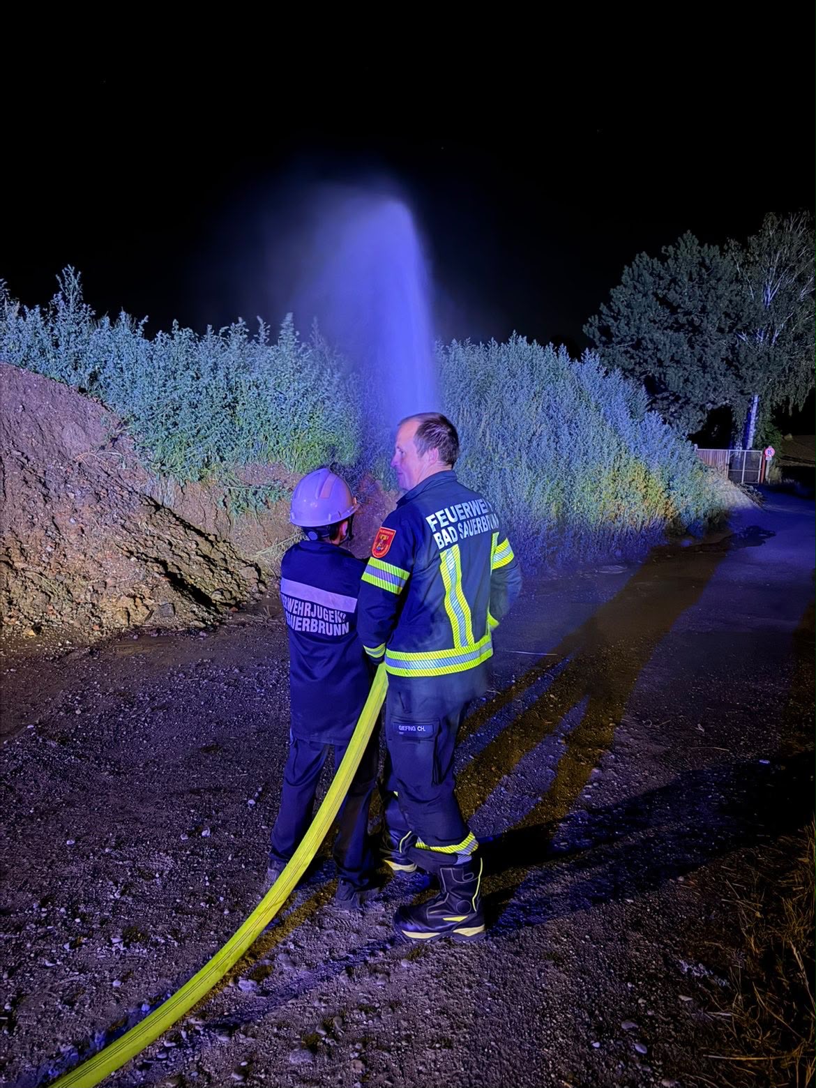 Feuerwehrjugend bei einer nächtlichen Übung mit Wasser